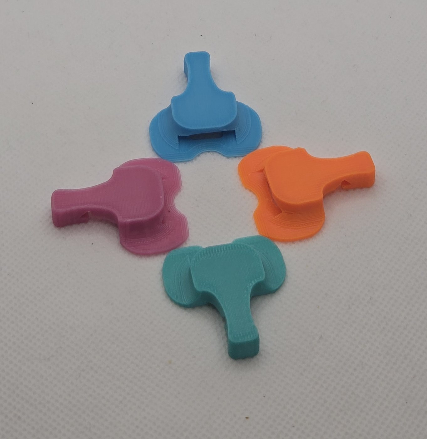 The four Elephant Cover colours printed in PETG - Orange, Sky Blue, Mint and Pink can covers