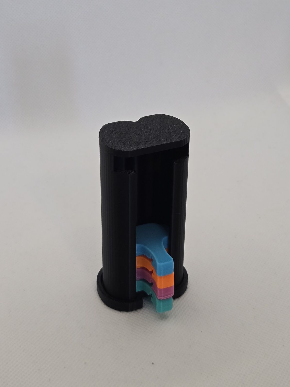 The display container standing upright, loaded with Elephant Cover can covers in orange, sky blue, mint and pink
