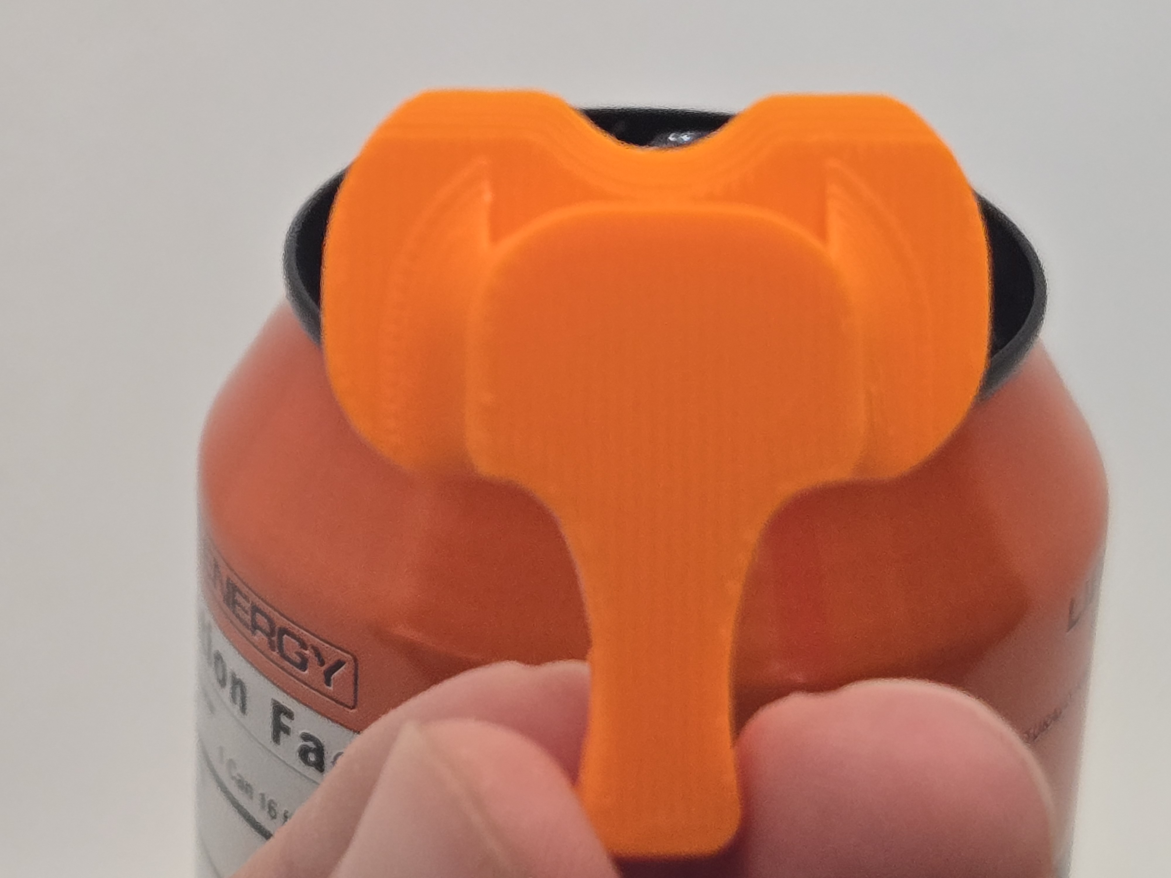 The Elephant Cover — trunk down, sealing the can, ears out like a real elephant face
